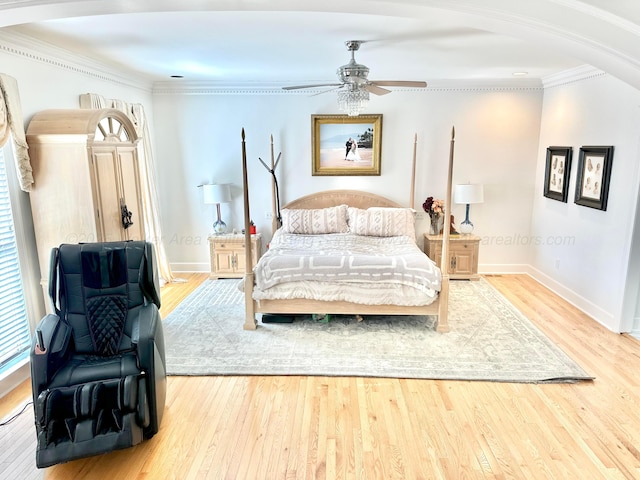 4963 Littleville Rd, Haleyville, AL 35565 - bedroom with wood finished floors, crown molding, arched walkways, and a ceiling fan