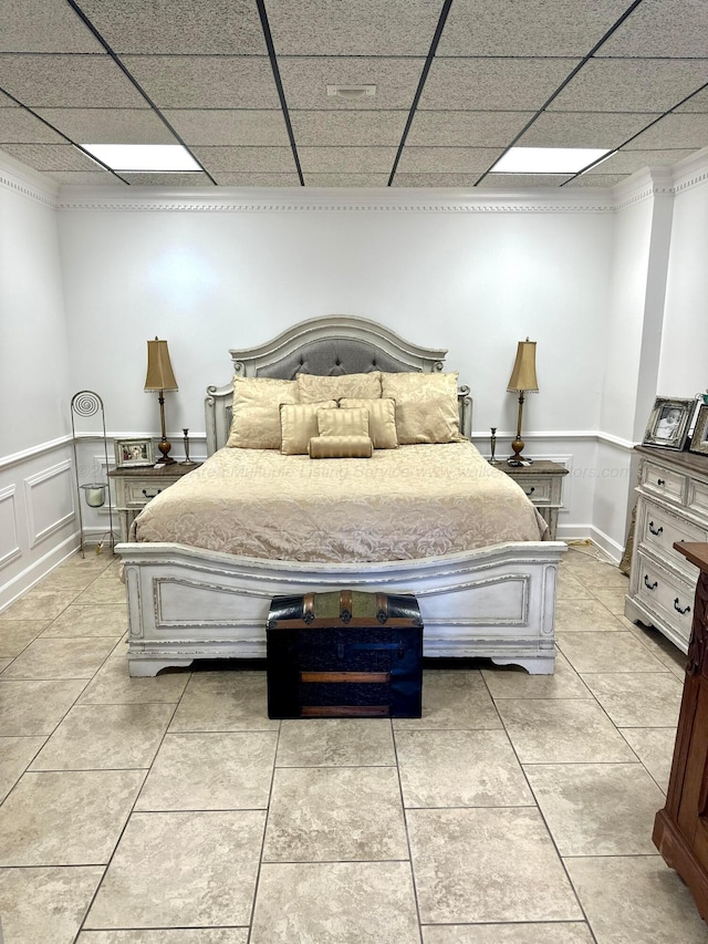 4963 Littleville Rd, Haleyville, AL 35565 - bedroom featuring light tile patterned floors, a paneled ceiling, and a wainscoted wall