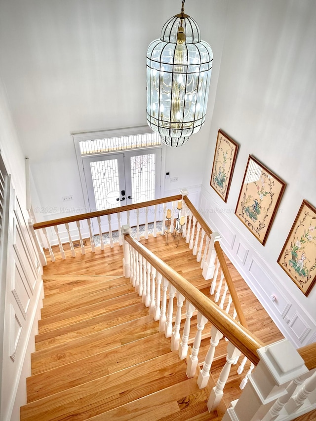 4963 Littleville Rd, Haleyville, AL 35565 - stairway with a high ceiling, french doors, wood finished floors, and a chandelier