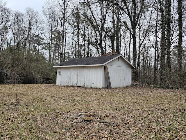 view of outbuilding with a lawn