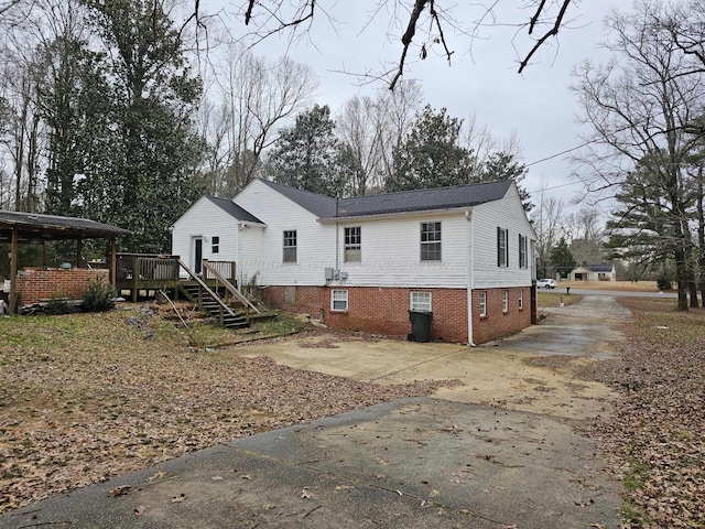 rear view of house featuring a wooden deck