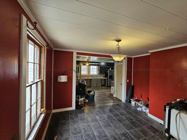 interior space featuring ornamental molding and sink