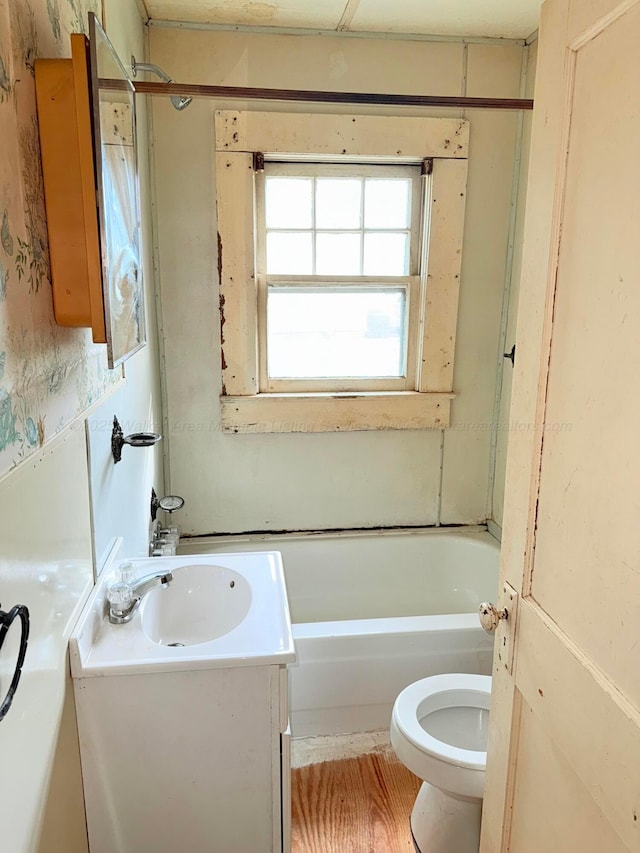 bathroom with shower / bathing tub combination, toilet, and vanity