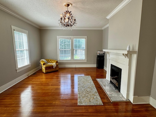 unfurnished room featuring plenty of natural light, a fireplace with flush hearth, crown molding, and wood finished floors
