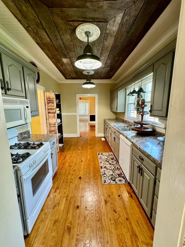kitchen featuring crown molding, white appliances, a sink, light wood-style floors, and wood ceiling