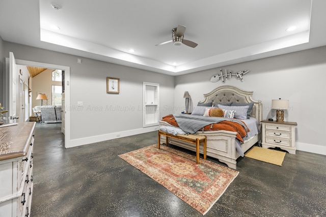 bedroom with a raised ceiling and ceiling fan