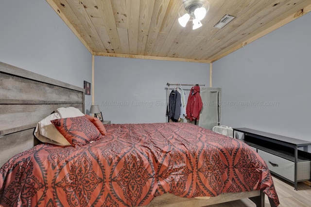 bedroom featuring visible vents, wooden ceiling, and wood finished floors