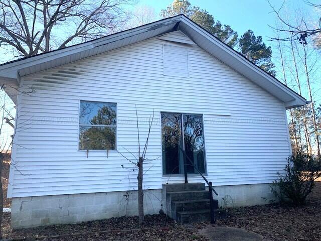 view of side of property featuring entry steps