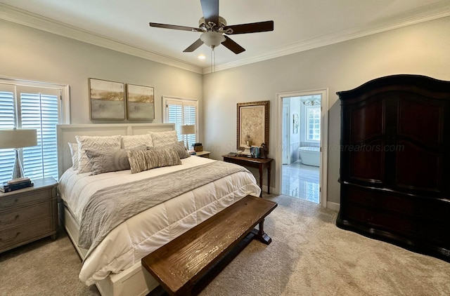 bedroom featuring ceiling fan, crown molding, light colored carpet, and ensuite bath