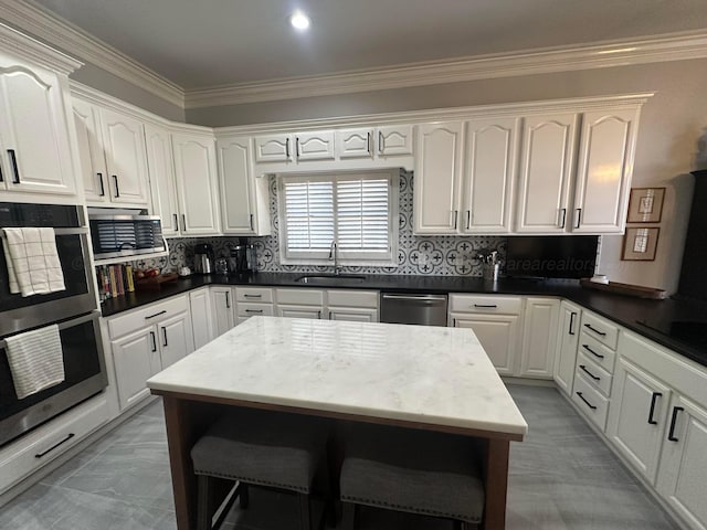 kitchen with tasteful backsplash, sink, and white cabinets