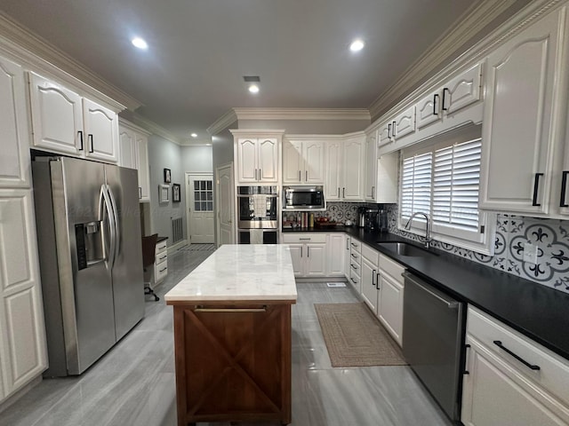 kitchen with sink, white cabinets, and appliances with stainless steel finishes