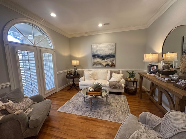 living room with hardwood / wood-style flooring and ornamental molding