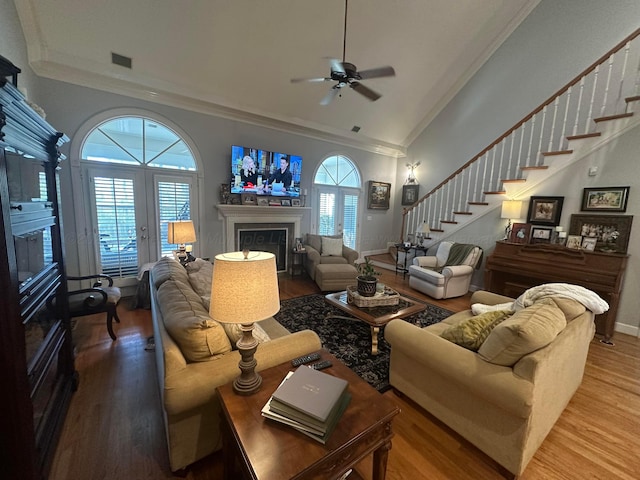 living room with hardwood / wood-style flooring, ornamental molding, a healthy amount of sunlight, and high vaulted ceiling