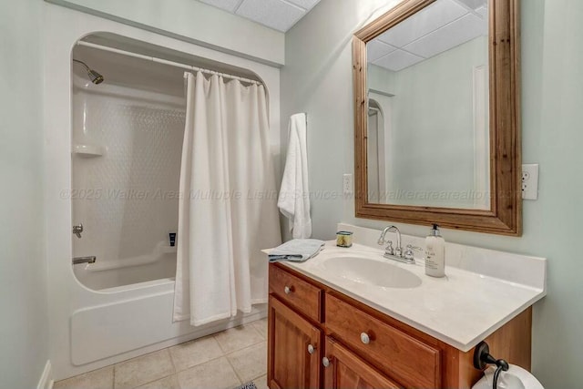 full bath featuring tile patterned flooring, a drop ceiling, shower / bath combination with curtain, and vanity