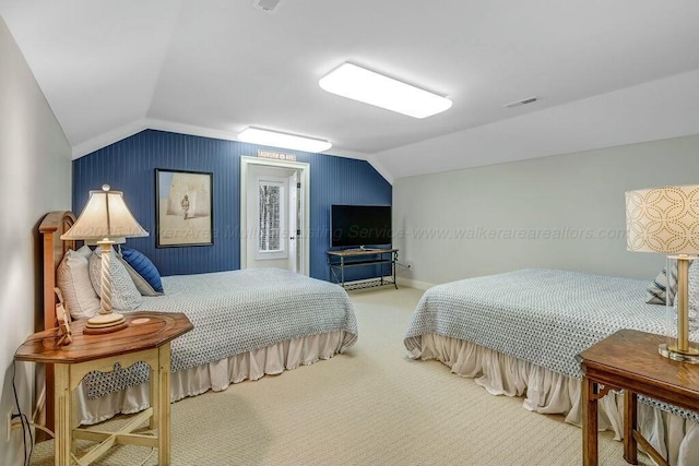 carpeted bedroom featuring visible vents, lofted ceiling, and baseboards