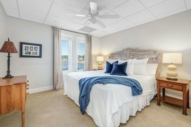 bedroom with baseboards, ceiling fan, a paneled ceiling, light carpet, and access to outside