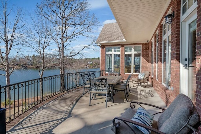 view of patio / terrace featuring a water view and outdoor dining space