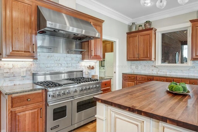 kitchen with ventilation hood, double oven range, butcher block countertops, crown molding, and tasteful backsplash