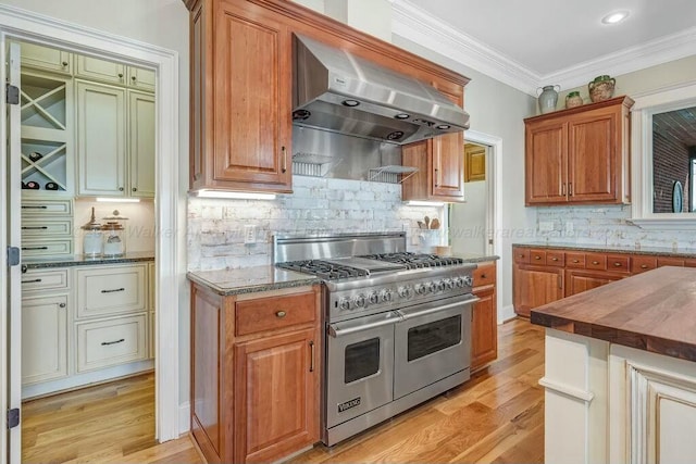 kitchen with light wood-style flooring, double oven range, ventilation hood, and ornamental molding