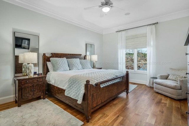 bedroom with a ceiling fan, baseboards, light wood-style floors, and crown molding