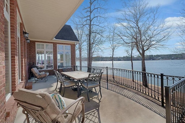 view of patio with outdoor dining space and a water view