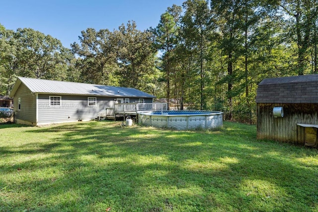 view of yard featuring a pool side deck and a shed