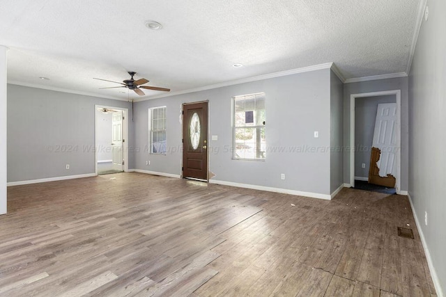 foyer with crown molding, ceiling fan, light hardwood / wood-style floors, and a textured ceiling