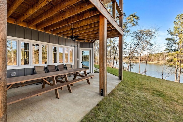 view of patio / terrace with ceiling fan and a water view