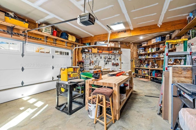 garage with a garage door opener and a workshop area