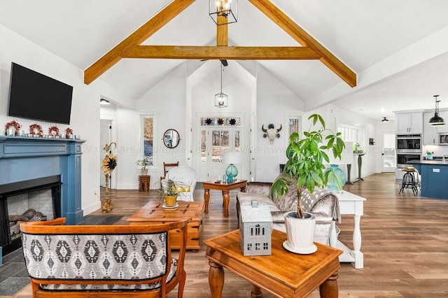 living room featuring hardwood / wood-style flooring, beamed ceiling, and high vaulted ceiling