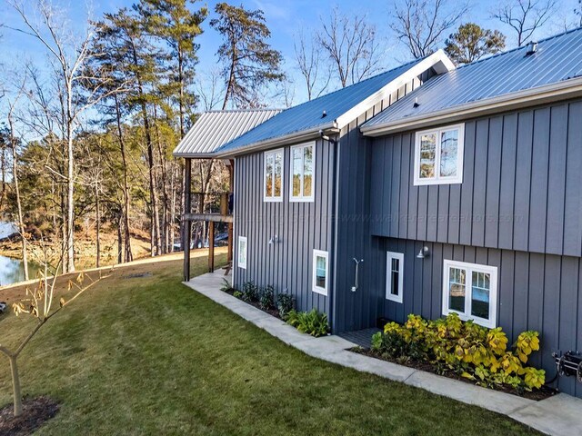 view of side of home with a yard