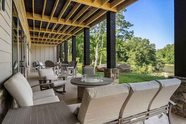 view of patio / terrace with an outdoor living space and a water view