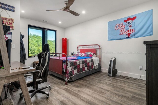 bedroom with ceiling fan and hardwood / wood-style flooring