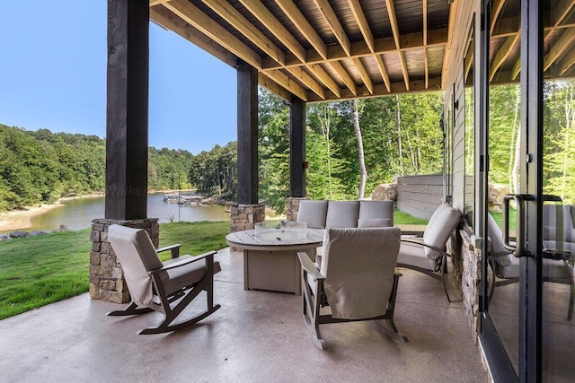 view of patio / terrace with a water view and a fire pit