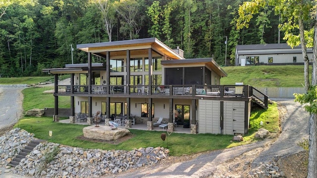 back of house featuring a patio area, a sunroom, and a wooden deck