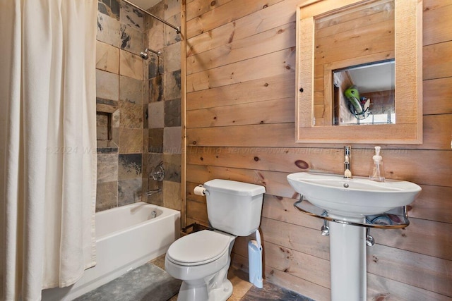 full bathroom with shower / bath combo, toilet, wooden walls, and sink