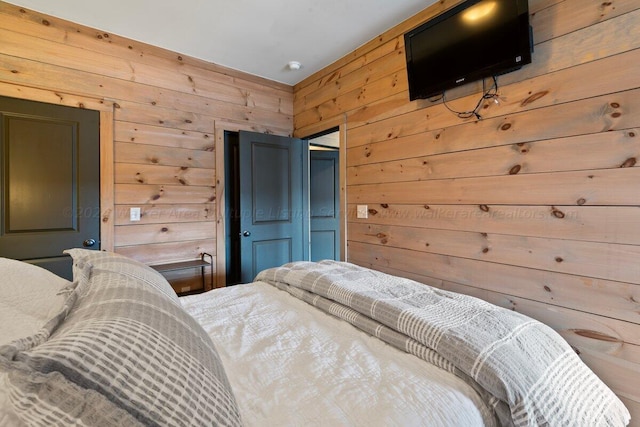 bedroom featuring wooden walls