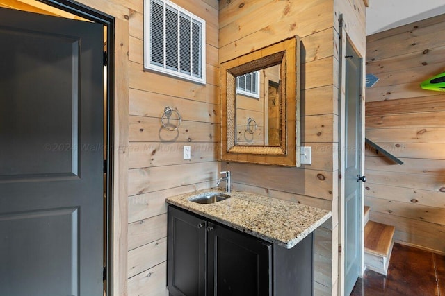 interior space with vanity and wooden walls