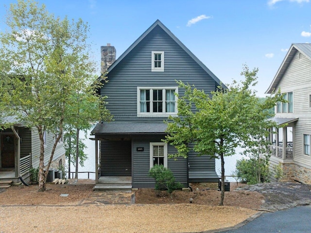 view of front of property with a porch and central AC unit