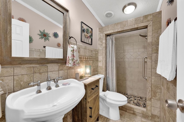 bathroom featuring vaulted ceiling, ornamental molding, a textured ceiling, and tile walls