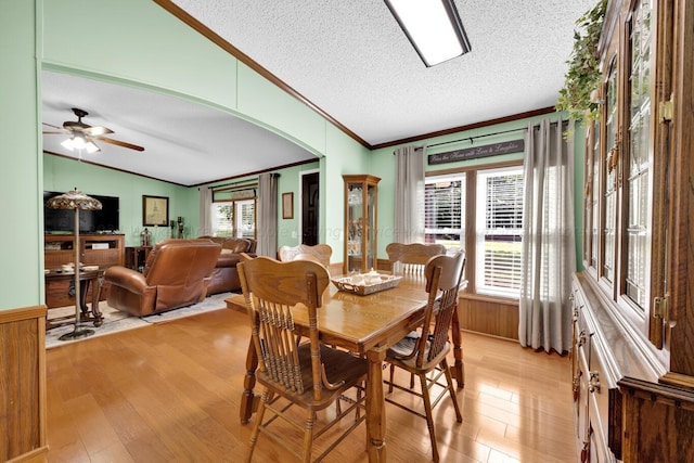 dining room with a wealth of natural light, light hardwood / wood-style floors, and a textured ceiling