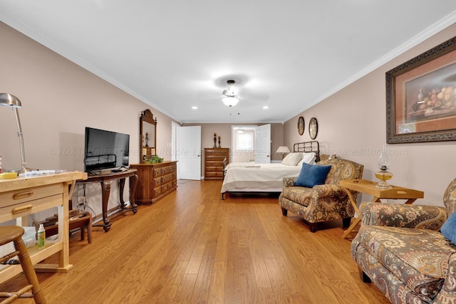 bedroom with ceiling fan, light hardwood / wood-style flooring, and ornamental molding