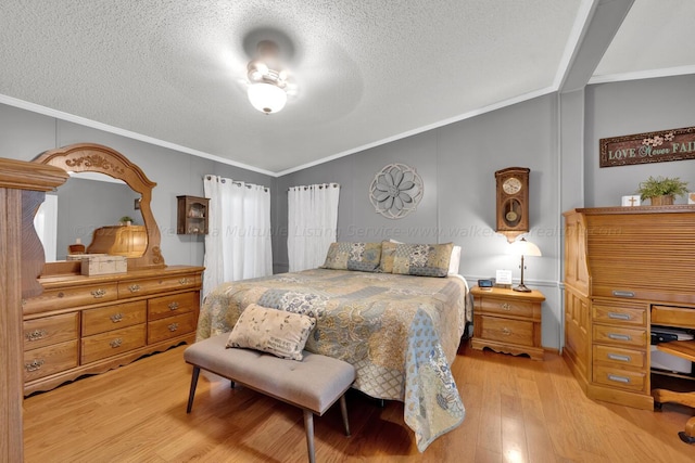 bedroom with ornamental molding, a textured ceiling, light hardwood / wood-style flooring, and lofted ceiling