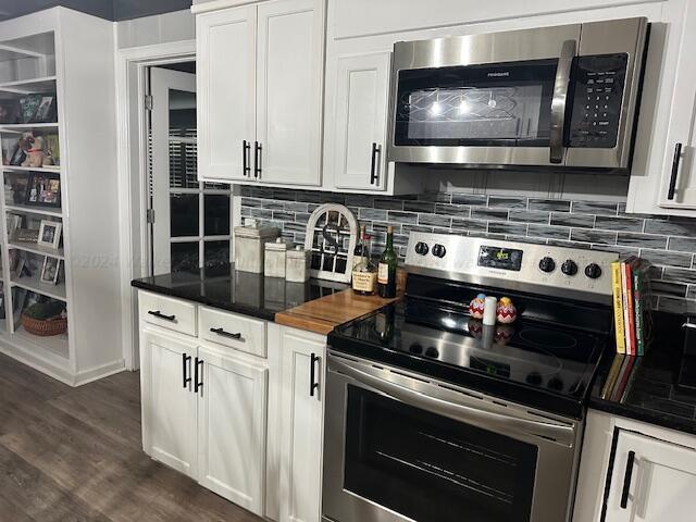 kitchen featuring white cabinets, stainless steel appliances, tasteful backsplash, and dark hardwood / wood-style floors