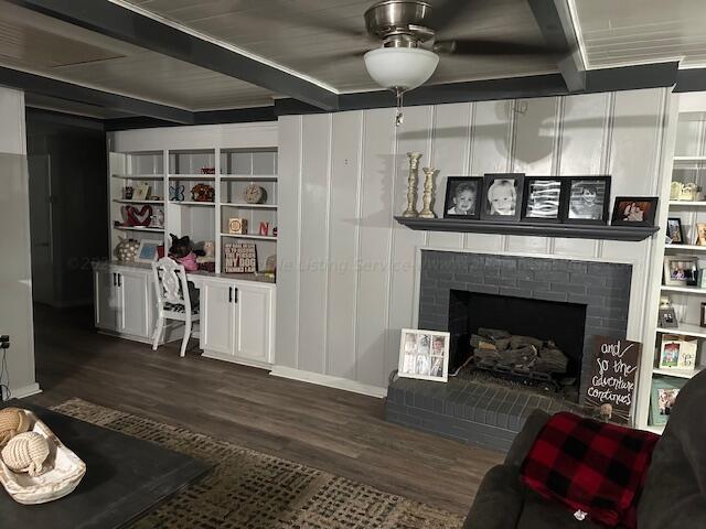 living room featuring a fireplace, ceiling fan, and dark hardwood / wood-style flooring