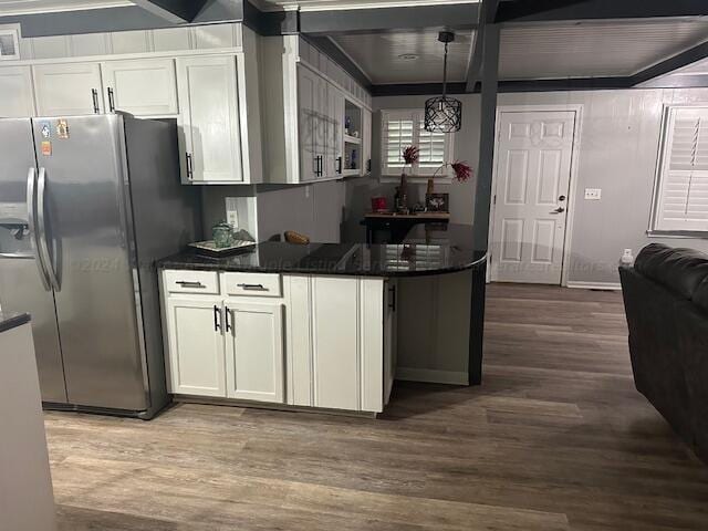 kitchen featuring pendant lighting, dark hardwood / wood-style flooring, white cabinets, and stainless steel refrigerator with ice dispenser