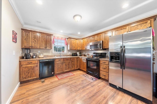 kitchen with light wood-type flooring, brown cabinets, crown molding, and black appliances