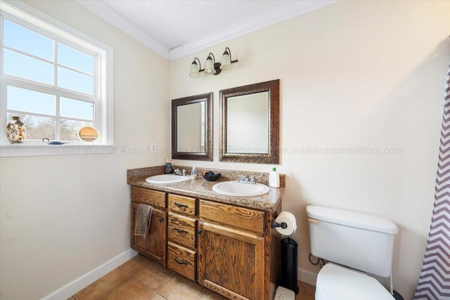 full bath featuring toilet, double vanity, ornamental molding, and a sink