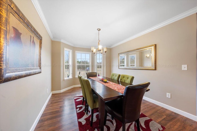 dining room featuring baseboards, a chandelier, dark wood finished floors, and crown molding