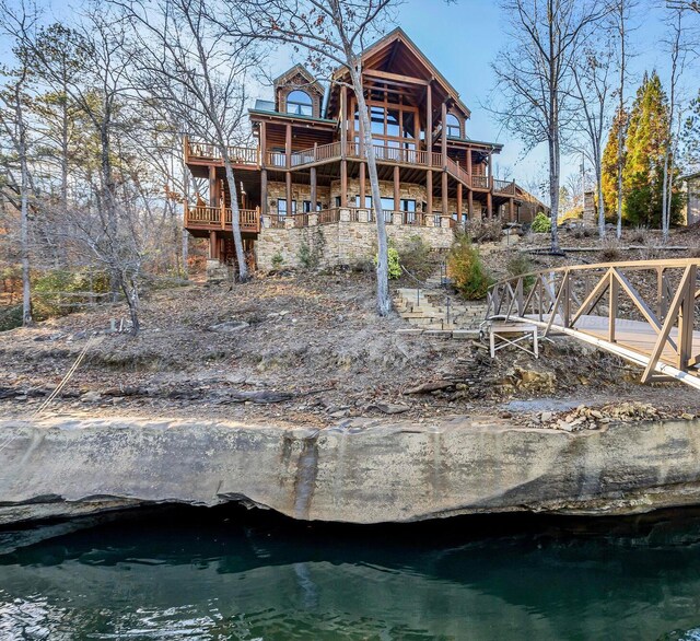 back of house featuring a deck with water view